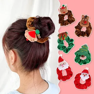 Detail view of plush Christmas scrunchies with Santa, reindeer and tree decorations