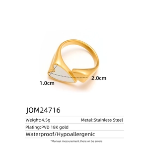 Macro detail of waterproof 18K gold plated stainless steel heart ring with white enamel