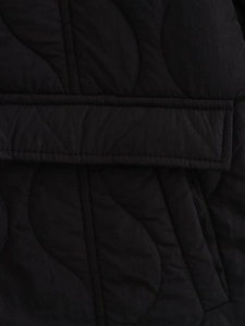 Detailed close-up of black quilted puffer jacket fabric with high-quality stitching