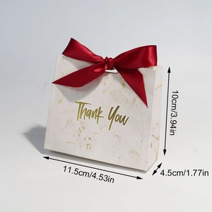 Detailed view of marble pattern gift bag with red ribbon and gold Thank You text dimensions