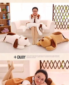 Detail of soft plush dog bolster pillows in white and brown with embroidered eyes