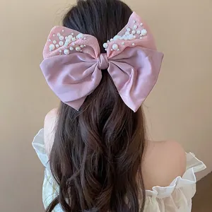 Pink satin bow hair clip with pearls for romantic women's elegant hairstyles