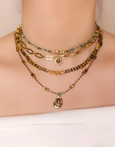 Macro shot of layered bohemian necklace with tiger eye beads and turquoise accents