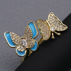 Macro view of blue enamel butterfly ring with white cubic zirconia and gold finish