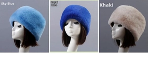Detailed view of plush faux rabbit fur hats in sky blue, royal blue, and khaki colors