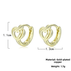 Detail of heart-shaped gold-plated copper hoop earrings with triple hollow design