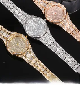 Detailed close-up of luxury iced-out quartz watches with full rhinestone dial and date window