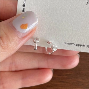 Close-up of small S925 sterling silver hoop earrings featuring clear zircon stone accents