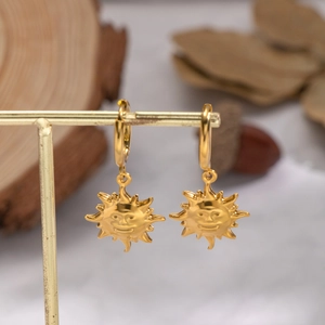 Vintage 18K gold plated sun face charm hoop earrings displayed on a golden jewelry stand