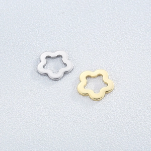 Macro shot of gold and silver stainless steel cutout flower pendants for DIY jewelry