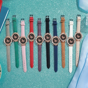 Flat lay of women's butterfly dial quartz watches in ten assorted colorful straps