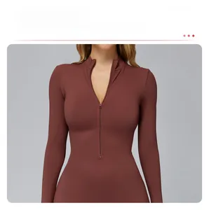 Detail of red-brown slim fit yoga jumpsuit featuring front zipper and removable pads