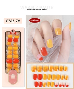 Detail of square press-on nails with orange yellow gradient and gold foil flakes