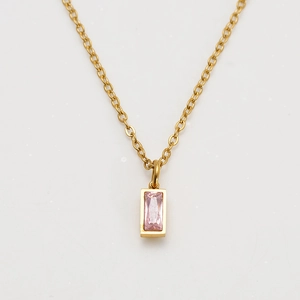 Macro detail of rectangle pink birthstone pendant on 18K gold plated chain necklace