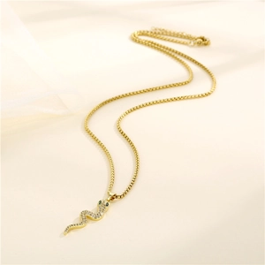 Golden snake pendant necklace with sparkling white and green zircon stones on box chain