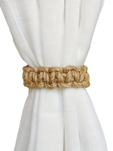 Close-up of handmade jute rope curtain tieback showing natural woven texture
