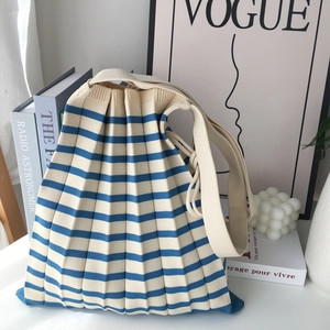 Minimalist knit tote bag with blue and beige stripes and a pleated texture