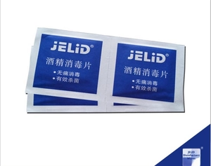 Macro detail of individually wrapped medical alcohol prep pads for earring sterilization