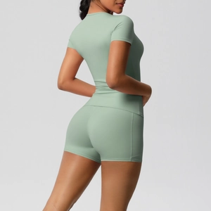 Slim fit mint green yoga set featuring short sleeve top and high waist leggings