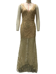Macro detail of gold sequin lace with vine patterns on a sleeveless V-neck evening gown