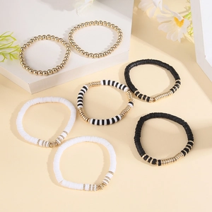 Set of 6 bohemian stackable bracelets with gold metal beads and black white heishi clay