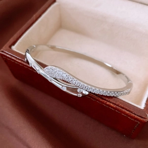 Detailed view of silver snake-shaped cuff bracelet with shimmering cubic zirconia stones