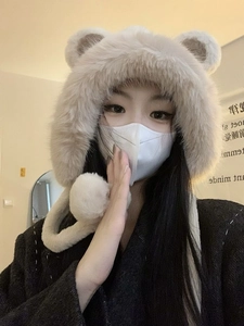 Detail of plush winter hat with cute bear ears and soft faux fur texture in beige