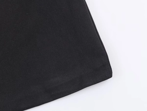 Gros plan sur la texture du tissu sergé noir et les coutures de qualité d'une robe