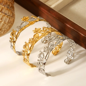 Tropical ocean themed open bangles featuring palm trees and sea creatures in gold and silver