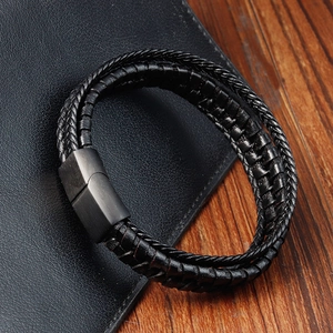 Close-up of black braided leather multi-layer bracelet with brushed metal magnetic clasp
