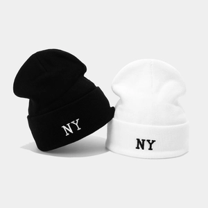 Set of black and white knitted beanies featuring NY embroidery for winter outdoor warmth