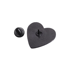 Detailed back view of heart pin badge showing metal texture and rubber clutch backing