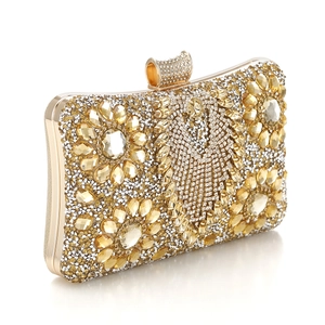 Detailed view of floral crystal pattern on a golden evening clutch bag with rhinestones