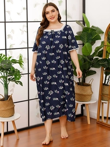 Detail of square neckline with white lace trim and bow on floral plus size nightgown