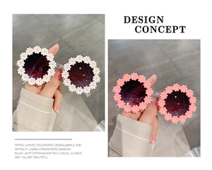Detail showing white and pink daisy flower shaped sunglasses for kids in cute ins style