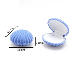 Shell shaped velvet jewelry box in light blue with white lining and size dimensions