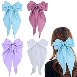 Detailed grid of satin oversized bow hair clips in four pastel colors with long ribbons