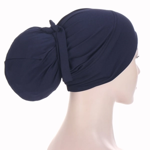 Detailed back view of a dark blue Muslim headscarf with decorative knotting structure