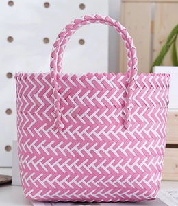 Close-up of pink and white geometric pattern on handcrafted woven tote basket bag