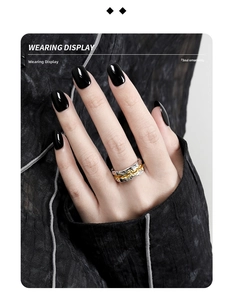 Detail of two-tone S925 silver ring with irregular lava texture on model finger