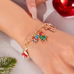 Detailed view of Christmas charm bracelet on wrist with festive holiday ornaments