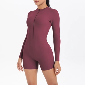 Detail of burgundy fitness bodysuit with half-zip neckline and sleek athletic fit