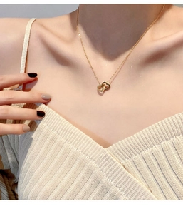 Detailed view of intertwined double heart pendant necklace with shimmering zircon accents