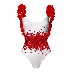Detail of bridal swimsuit featuring 3D red rose petals on white fabric straps