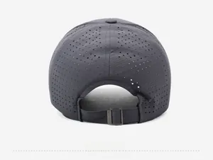 Detail of grey baseball cap back with laser-cut perforations and metal buckle strap