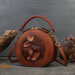 Vintage carved leather round handbag with rabbit pattern, top handle shoulder crossbody bag.