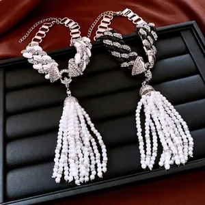 Vintage long pearl tassel necklace with chunky chains and rhinestones on red silk