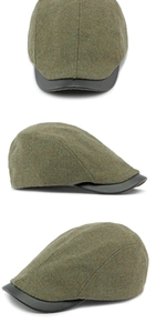 Detail view of moss green wool tweed beret with black leather brim and rustic texture