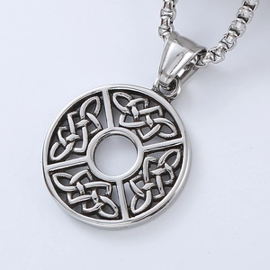 Close-up of vintage silver necklace featuring a Celtic knot circular pendant on white background