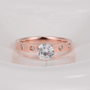 Minimalist rose gold stainless steel ring with a round zircon in a six-claw setting
